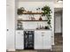 Chic bar area with open shelving, stylish decor, and a built-in wine fridge for entertaining at 6767 Sonora Blvd, Brownsburg, IN 46112