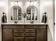 Bathroom featuring double sinks, large mirrors, and modern fixtures at 6767 Sonora Blvd, Brownsburg, IN 46112
