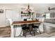 Open-concept dining area showcases a natural wood table, white chairs, and seamless flow to the living room at 6767 Sonora Blvd, Brownsburg, IN 46112