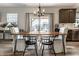 Inviting dining room featuring a rustic wood table, stylish chandelier, and sliding glass doors to the backyard at 6767 Sonora Blvd, Brownsburg, IN 46112