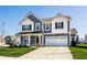 Charming two-story home with a manicured lawn, covered porch, and attached two-car garage at 6767 Sonora Blvd, Brownsburg, IN 46112