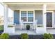 Inviting front porch with rocking chairs, a porch swing, and charming curb appeal at 6767 Sonora Blvd, Brownsburg, IN 46112