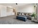 Spacious living room with plush carpeting, a comfortable couch, and a decorative ottoman at 6767 Sonora Blvd, Brownsburg, IN 46112