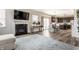 Open-concept living area showcasing a fireplace and seamless flow into the kitchen at 6767 Sonora Blvd, Brownsburg, IN 46112