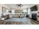 Bright living room with a fireplace, modern decor, neutral sectional, and luxury vinyl flooring at 6767 Sonora Blvd, Brownsburg, IN 46112
