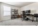 Bright office space featuring a comfortable desk, shelving, and natural light at 6767 Sonora Blvd, Brownsburg, IN 46112