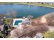 Aerial view of a community pool and lake surrounded by townhomes and mature trees at 7454 Harbour Isle # 158, Indianapolis, IN 46240