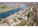 Aerial view of a lake community with houses, townhomes, green spaces, and winding roads at 7454 Harbour Isle # 158, Indianapolis, IN 46240