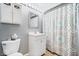 Cozy bathroom with a vanity, toilet, and a shower with a patterned curtain at 7454 Harbour Isle # 158, Indianapolis, IN 46240
