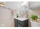 Bathroom featuring modern vanity, round mirror, and wall decor at 7454 Harbour Isle # 158, Indianapolis, IN 46240