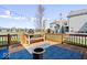 Inviting backyard deck with furniture, outdoor grill, lighting, and pond view at 7454 Harbour Isle # 158, Indianapolis, IN 46240