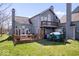 Two-story house featuring a wooden deck, second story balcony, and well-maintained lawn at 7454 Harbour Isle # 158, Indianapolis, IN 46240