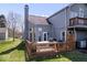 The backyard features a deck, second story balcony, mature trees, and manicured lawn at 7454 Harbour Isle # 158, Indianapolis, IN 46240