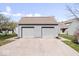 Two-car detached garage with gray siding and a driveway, adjacent to the house at 7454 Harbour Isle # 158, Indianapolis, IN 46240