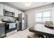 Functional kitchen with stainless steel appliances and a dining area at 7454 Harbour Isle # 158, Indianapolis, IN 46240