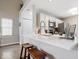 Bright kitchen features white cabinets, modern appliances, and a breakfast bar with seating at 7454 Harbour Isle # 158, Indianapolis, IN 46240