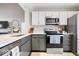 Modern kitchen with stainless steel appliances, sleek countertops, and a stylish backsplash at 7454 Harbour Isle # 158, Indianapolis, IN 46240