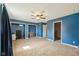Spacious bedroom with blue walls, ceiling fan, and closets ready for new flooring at 7974 N 500 W, McCordsville, IN 46055