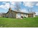 Stone house with lawn, sliding glass doors, and outdoor seating at 7974 N 500 W, McCordsville, IN 46055