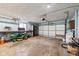 Spacious garage with lawn mower, storage shelves, and overhead door at 7974 N 500 W, McCordsville, IN 46055