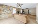 Comfortable living room with stone accent wall, neutral sofa, and two ceiling fans at 7974 N 500 W, McCordsville, IN 46055
