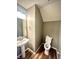 Bathroom featuring sink, mirror, and toilet with neutral-colored walls and new wood flooring at 8051 Retreat Ln, Indianapolis, IN 46259