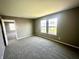 Bedroom features neutral colors, plush carpeting and natural light offering a comfortable and inviting space at 8051 Retreat Ln, Indianapolis, IN 46259