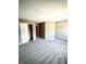 This bedroom has neutral paint, plush gray carpet and a large walk-in closet at 8051 Retreat Ln, Indianapolis, IN 46259