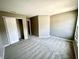 This bedroom has neutral paint, plush gray carpet and a large walk-in closet at 8051 Retreat Ln, Indianapolis, IN 46259
