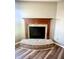 Living room area featuring a fireplace with brick base and mantel and new hardwood floors at 8051 Retreat Ln, Indianapolis, IN 46259