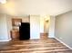 Kitchenette area with wood cabinets, black refrigerator, new flooring, and neutral-colored walls at 8051 Retreat Ln, Indianapolis, IN 46259