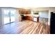 Open-concept kitchen and eating area with wood flooring and stainless steel appliances near a glass sliding door at 8051 Retreat Ln, Indianapolis, IN 46259