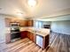 Well-lit kitchen featuring stainless steel appliances and wood cabinets that opens up to the living room at 8051 Retreat Ln, Indianapolis, IN 46259