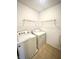 This laundry room features tile floors and a side by side washer and dryer at 8051 Retreat Ln, Indianapolis, IN 46259