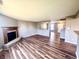 Open-concept living room features a cozy fireplace, seamless flow, and beautiful, durable wood flooring at 8051 Retreat Ln, Indianapolis, IN 46259