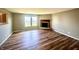 Comfortable living room featuring a traditional fireplace, bright windows, and stylish hardwood floors at 8051 Retreat Ln, Indianapolis, IN 46259