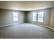 Bright living room boasts large windows, neutral paint, and plush carpet, creating a welcoming atmosphere at 8051 Retreat Ln, Indianapolis, IN 46259