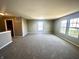 Spacious living room featuring neutral paint, plush carpet, and large windows for ample natural light at 8051 Retreat Ln, Indianapolis, IN 46259