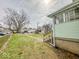 Large backyard featuring green lawn and mature trees, offering ample space for recreation at 831 Wallace Ave, Indianapolis, IN 46201
