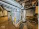 View of the furnace and water heater in the unfinished basement at 831 Wallace Ave, Indianapolis, IN 46201