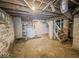 Unfinished basement with concrete flooring and brick walls at 831 Wallace Ave, Indianapolis, IN 46201