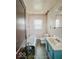 Bathroom with a combined tub and shower, commode, and blue vanity at 831 Wallace Ave, Indianapolis, IN 46201