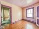 Cozy bedroom with hardwood floors and a window for natural light at 831 Wallace Ave, Indianapolis, IN 46201