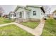 Exterior of home featuring charming front porch and well-maintained lawn and sidewalk at 831 Wallace Ave, Indianapolis, IN 46201