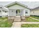 Attractive home featuring a welcoming lattice-covered front porch and well-manicured landscaping at 831 Wallace Ave, Indianapolis, IN 46201
