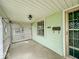 View of porch with lattice, light fixture, and secure entry door at 831 Wallace Ave, Indianapolis, IN 46201