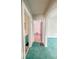 Hallway view from bathroom towards bedroom with green carpet at 831 Wallace Ave, Indianapolis, IN 46201