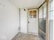 A mud room with a white door, concrete floor, white walls, and an overhead light at 831 Wallace Ave, Indianapolis, IN 46201
