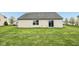Backyard features a well-maintained lawn and a home with sliding glass door, inviting outdoor enjoyment at 8660 Benjamin Ln, Avon, IN 46123