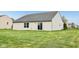 Backyard features a well-maintained lawn and a home with sliding glass door, inviting outdoor enjoyment at 8660 Benjamin Ln, Avon, IN 46123
